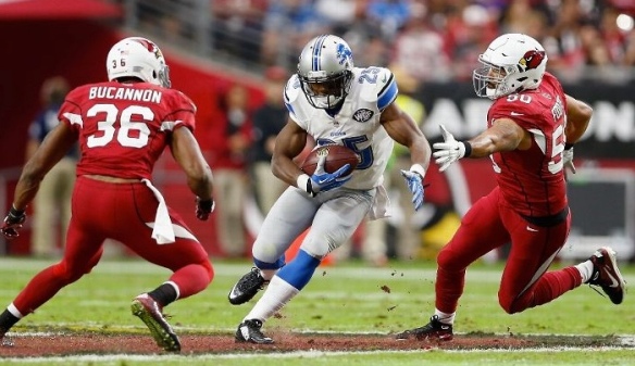 GLENDALE, AZ - NOVEMBER 16: Running back Theo Riddick #25 of the Detroit Lions runs with the football after a reception against strong safety Deone Bucannon #36 and middle linebacker Larry Foote #50 in the second quarter during the NFL game at the University of Phoenix Stadium on November 16, 2014 in Glendale, Arizona. (Photo by Christian Petersen/Getty Images)