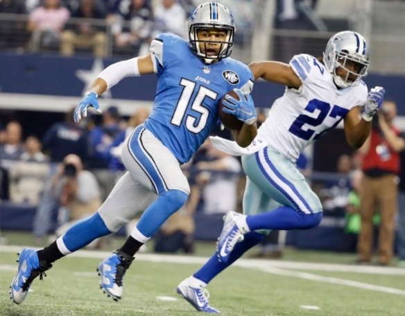 ARLINGTON, TX - JANUARY 04: Detroit Lions wide receiver Golden Tate (15) runs in for a touchdown as Dallas Cowboys free safety J.J. Wilcox (27) defends during the first half of an NFL wildcard playoff football game, Sunday, Jan. 4, 2015, in Arlington, Texas. (AP Photo/Tony Gutierrez)